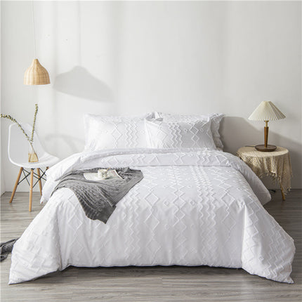 Artistic Bohemian Quilt Cover Set displayed in a bedroom, featuring a white quilt with pillowcases and a cozy, inviting atmosphere.