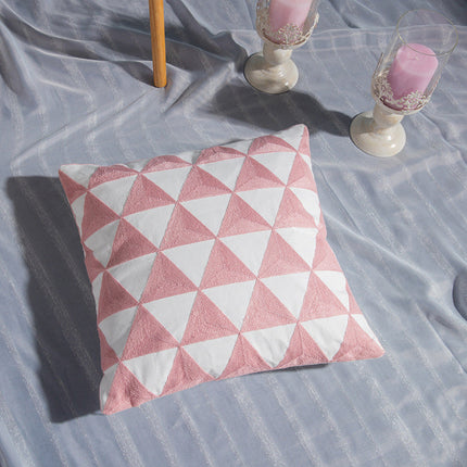 Geometric Embroidered Cotton Cover with pink and white triangle patterns on a bed.