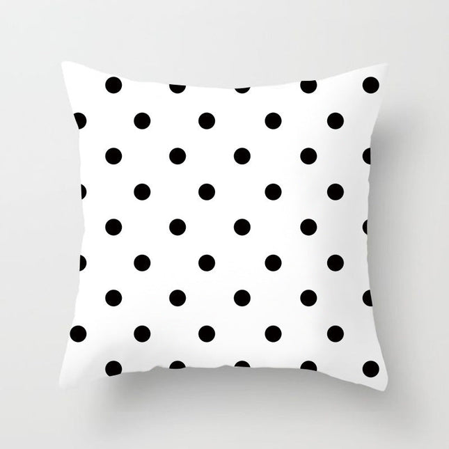 Dot printed sofa cushion cover with black polka dots on white background.