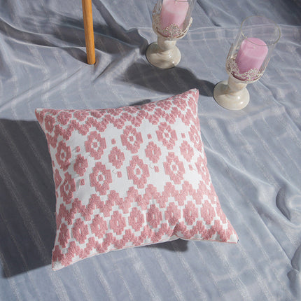 Geometric Embroidered Cotton Cover with intricate pattern on a pillow.