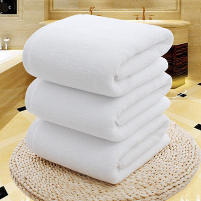 Pure cotton thickened bath towel stack in a luxurious bathroom setting.
