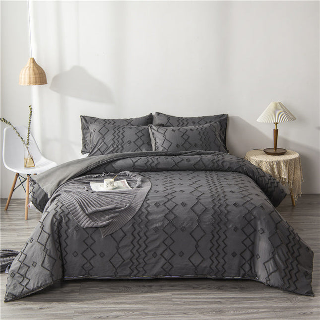 Artistic Bohemian Quilt Cover Set in gray, featuring intricate geometric patterns on a neatly arranged bed.