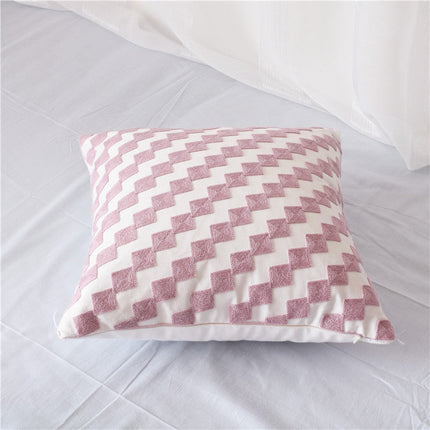 Geometric Embroidered Cotton Cover on white surface with intricate pink geometric embroidery.