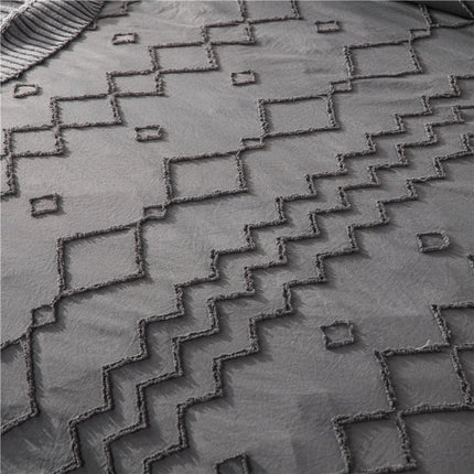Artistic Bohemian Quilt Cover Set with geometric pattern on soft gray fabric, showcasing intricate design.