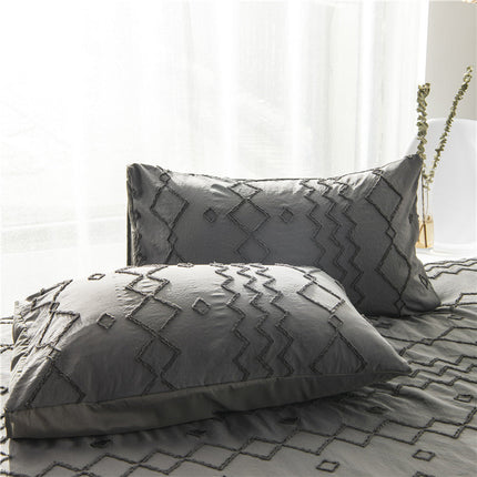 Artistic Bohemian Quilt Cover Set with geometric patterns and soft fabric pillows in neutral tones.